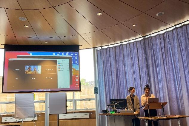 SoMA Representatives Laila Rajani and Gabriele Zukauskaite welcoming virtual and on-site attendees to the symposium. Photo credit: Michelle Potiaumpai